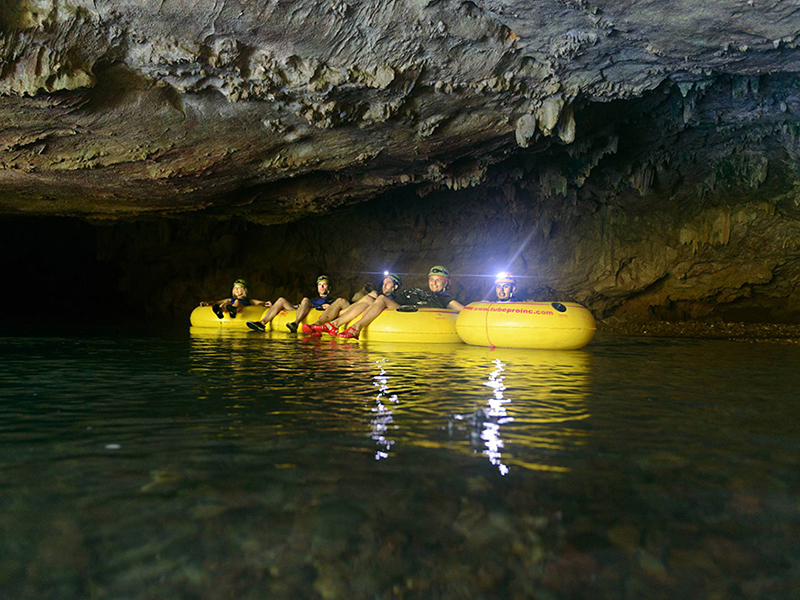 Cave tubing takes participants on drifts through underground rivers. Cave tubing takes participants on drifts through underground rivers.